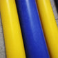 A green pom nylon rod held by a hand against a black background