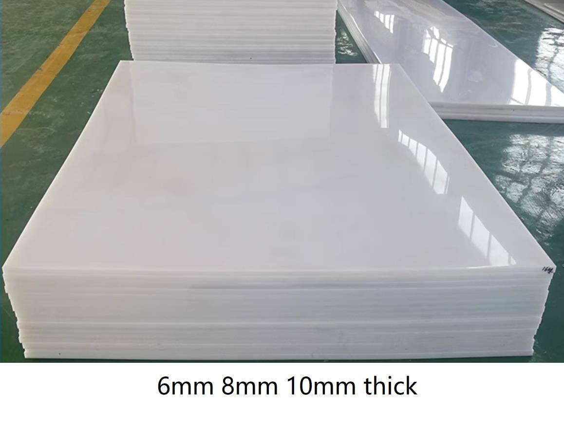White UHMWPE plastic sheet stock on table